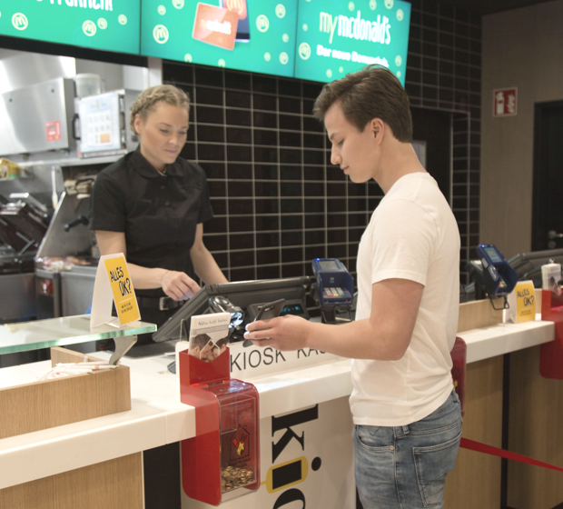 boy scanning his phone in a McDonalds store